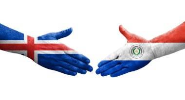 Ellerinde Paraguay ve İzlanda bayrakları arasında el sıkışma, izole şeffaf görüntü.