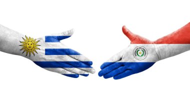 Ellerinde Paraguay ve Uruguay bayrakları arasında el sıkışma, izole şeffaf görüntü.
