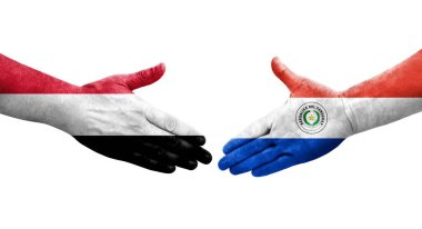 Ellerinde Paraguay ve Yemen bayrakları arasında el sıkışma, izole şeffaf görüntü.