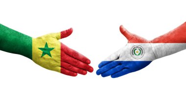 Ellerinde Paraguay ve Senegal bayrakları arasında el sıkışma, izole şeffaf görüntü.