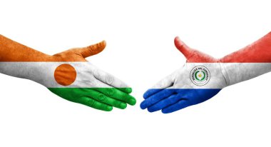 Ellerinde Paraguay ve Nijer bayrakları arasında el sıkışma, izole şeffaf görüntü.