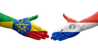 Ellere boyanmış Paraguay ve Etiyopya bayrakları arasındaki el sıkışma, izole şeffaf görüntü.