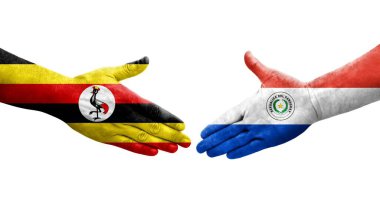 Ellerinde Paraguay ve Uganda bayrakları arasında el sıkışma, izole şeffaf görüntü.