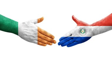 Ellerinde Paraguay ve İrlanda bayrakları arasında el sıkışma, izole şeffaf görüntü.