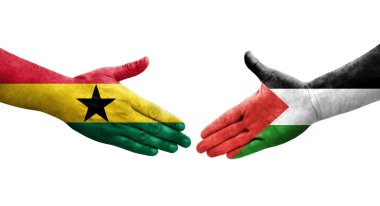 Filistin ve Gana bayrakları arasındaki el sıkışma ellerinde resmedilmiş şeffaf bir görüntü.