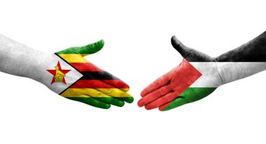 Filistin ve Zimbabwe bayrakları arasındaki el sıkışma ellerinde izole şeffaf görüntü.