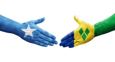 Saint Vincent Grenadines ve Somali bayrakları arasındaki el sıkışma, izole şeffaf görüntü.