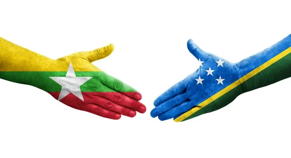 stock image Handshake between Solomon Islands and Myanmar flags painted on hands, isolated transparent image.