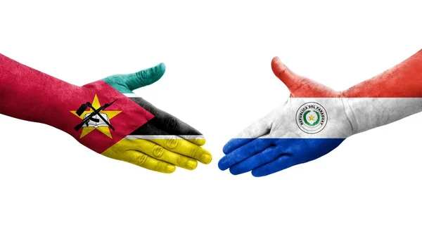 stock image Handshake between Paraguay and Mozambique flags painted on hands, isolated transparent image.