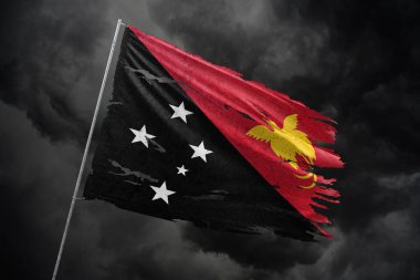 Papua Yeni Gine 'nin koyu gökyüzü arka planında yırtık bayrağı.