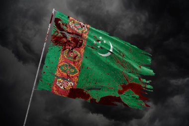Türkmenistan, kan lekeleriyle karanlık gökyüzü arka planında bayrak yırttı.