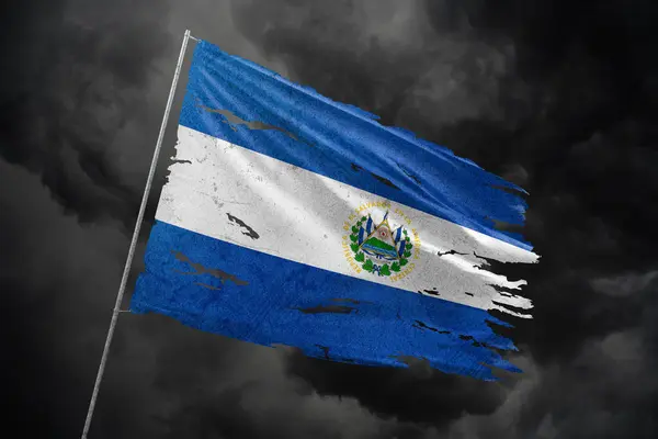 stock image El Salvador torn flag on dark sky background.