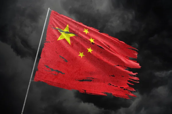 China torn flag on dark sky background.