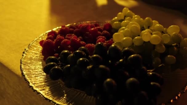Green Black Grapes Ripe Raspberries Plate Dusk Close — Stock Video