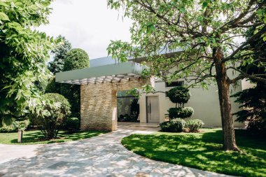 Beautiful country house in a modern style . Front entrance and courtyard of a beautiful modern stone cottage