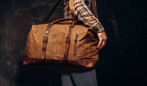 Brown duffel bag on men's shoulder
