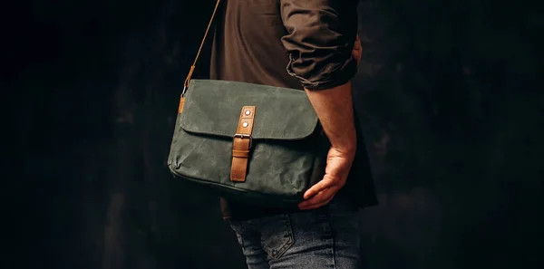 Man with duffle bag on shoulder. leather and canvas bag