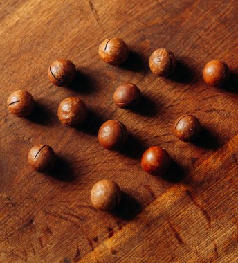 Organic Macadamia nut on wooden table clipart