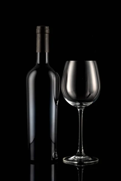 黒の背景の前にワインボトルとワイングラス — ストック写真