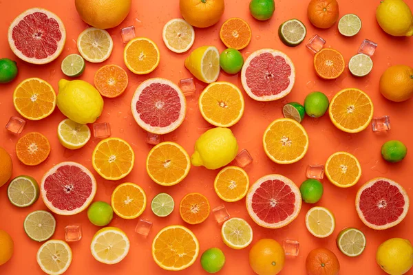 果香和多汁水果的概念 顶部视图 美味的水果背景由许多色彩艳丽的新鲜切碎 半熟的柑橘类水果和橙色背景的整个柑橘类水果制成 — 图库照片