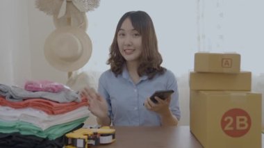 Business concept of 4k Resolution. Asian woman talking to customers online in office.