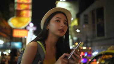 Travel concept of 4k Resolution. Asian woman using phone on the road while traveling.