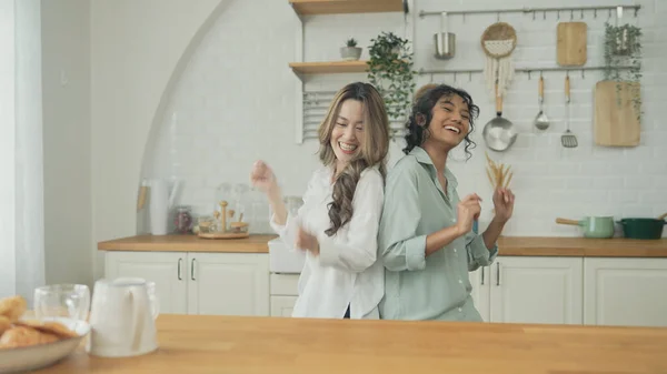 stock image Holiday concept of 4k Resolution. Asian women dancing together in the kitchen. Young women are in a mutual lesbian love relationship.