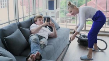 Family concept of 4k Resolution. Caucasian couple cleaning in the house. taking advantage.