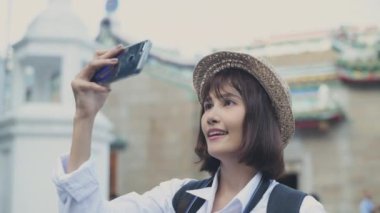 Travel concept of 4k Resolution. Asian woman taking pictures on the street while traveling.
