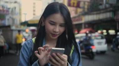 Travel concept of 4k Resolution. Asian woman using phone on the road while traveling.