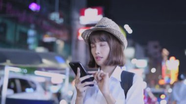 Travel concept of 4k Resolution. Asian woman using phone on the road while traveling.