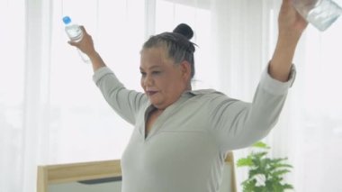 Exercise concept of 4k Resolution. Asian elderly woman exercising at home.