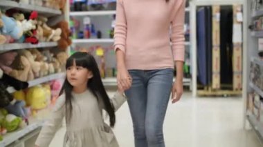 Shopping concepts of 4k Resolution. Asian mother and daughter are buying dolls in the mall.