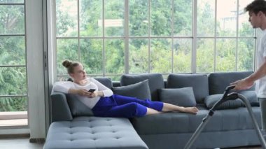 Family concept of 4k Resolution. Caucasian couple cleaning in the house. taking advantage.