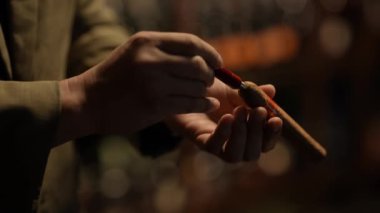 Night club concept of 4k Resolution. Close-up of the hand of an Asian man cutting a cigar in a restaurant.