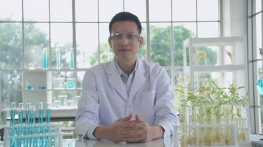 Research concept of 4k resolution. Asian scientists are describing plant growth observations in the laboratory.