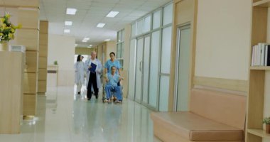 Hastane konsepti 4k Kararlılık. Hemşireler ve hastalar koridorda yürür, hastaneye koşarlar..