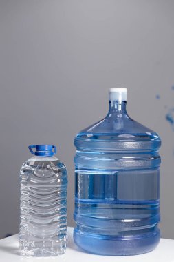 Two water bottles. Isolated on gray background. High quality photo