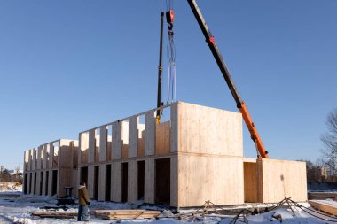 The construction process of a new and modern modular house made of composite sip panels on a sunny winter day. High quality photo
