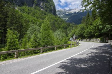 Amazing views of Trenta Valley Bovec Slovenia, long road with Soca river and high mountains, Triglav natioonal park Julian Alps, blue sky