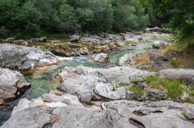 Amazing wild water in mala korita Soce valley, small pure clear turquoise flowing stream through stones gorge