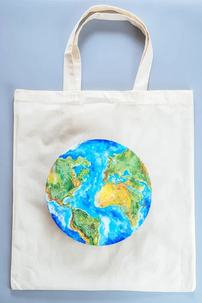 Eco shopping bag with the pattern of the planet. Save planet earth. Sustainability and ecological lifestyle. High quality photo