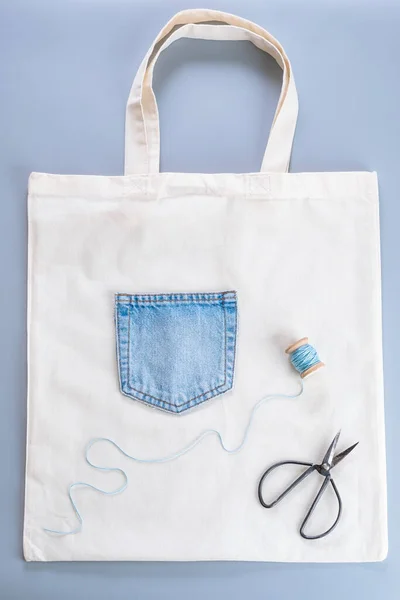 Old jeans reusing idea. Used clothes. Crafting with denim. Top view. Zero waste lifestyle. The concept of worm out clothing recycling. High quality photo