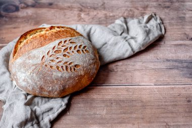 Rustic Italian Bread with Lievito Madre on a wooden table. Organic and healthy bread on sourdough . High quality photo