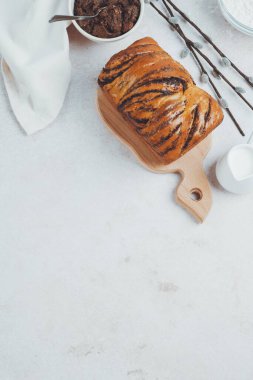Traditional Romanian sweet bread cozonac with ingredients on table. Easter baking sourdough. Healthy food. top view. space for text. High quality photo