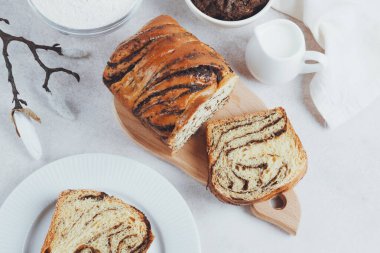 Traditional Romanian sweet bread cozonac decorated bloom. Slices of fresh bread on a plate. Spring and Easter baking. Healthy and organic food. top view. space for text. High quality photo