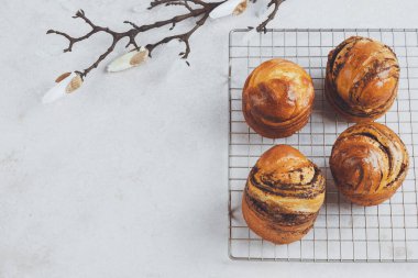Easter sweet bread on a grid decorated with bloom. Spring baking. Healthy and organic food. top view. space for text. High quality photo