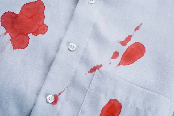 Blood staines a gray shirt. Stained clothing. daily life stain and cleaning concept. top view. High quality photo