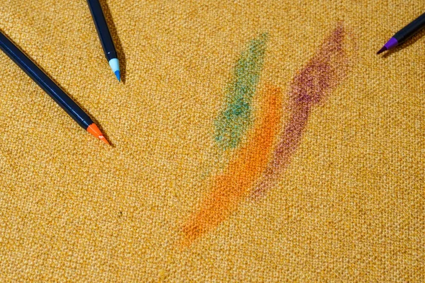 Drawing fabric or upholstery on the couch with colored felt-tip pens. Spoiled furniture fabric. daily life dirty stain. Cleaning stain concept. High quality photo