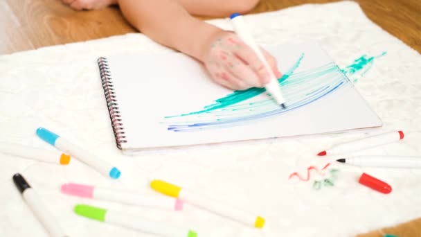 Kağıt Üzerinde Yeşil Keçeli Kalemle Bir Çocuğun Çizimi Döşeme Mobilyalarındaki — Stok video